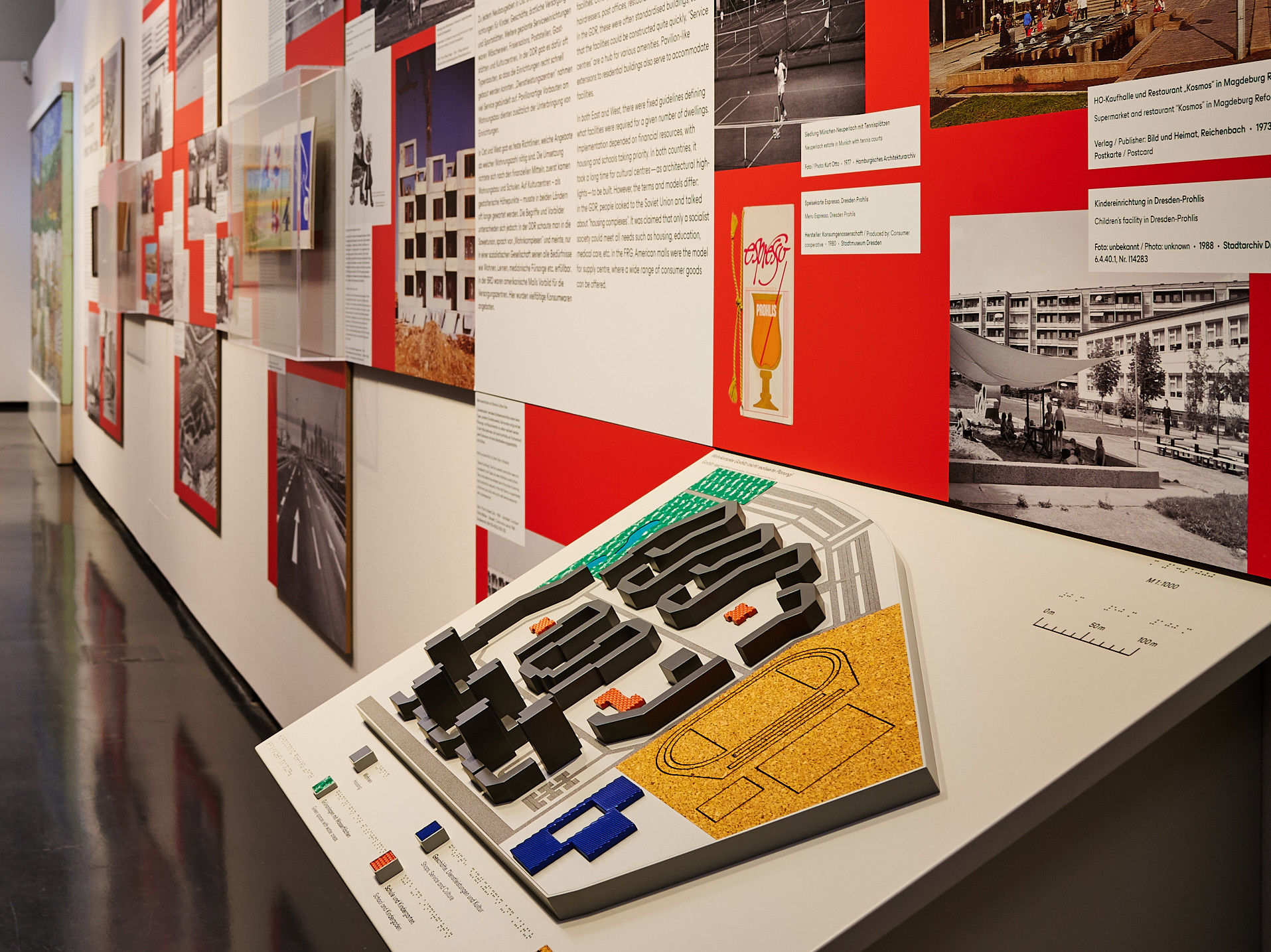 AI generated: The image shows a group of children playing in a playground and crawling and climbing through a colourfully painted wall with circles. Large residential buildings can be seen in the background.